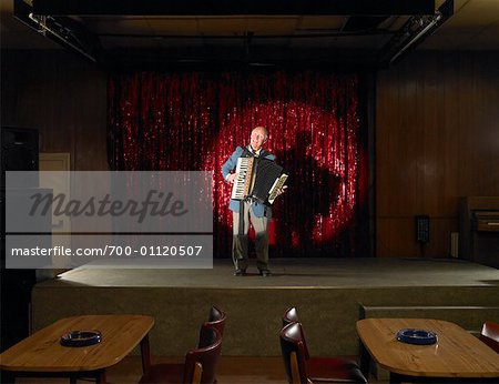 Man Playing Accordion in Empty Bar, London, England