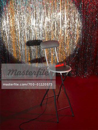 Empty Chair and Microphone on Stage