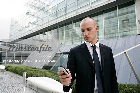 Businessman Looking at Cell Phone
