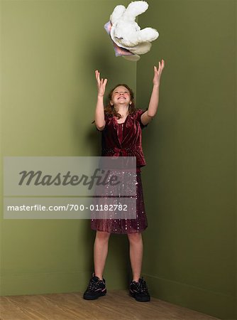 Girl Throwing Stuffed Animal in Air