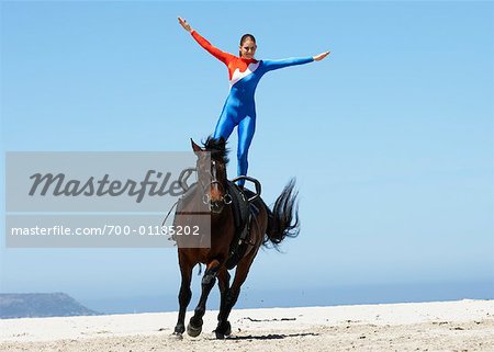 Circus Performer Standing on Horse