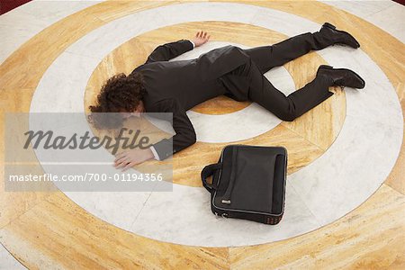 Businessman Lying at Bottom of Staircase