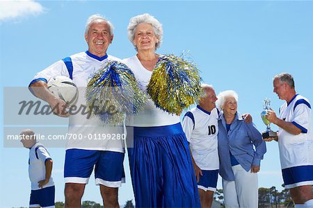 Soccer Players and Cheerleader on Soccer Pitch