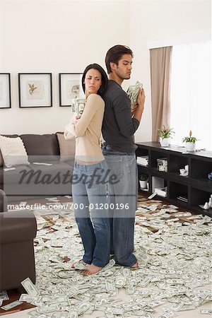 Couple at Home with Pile of Money