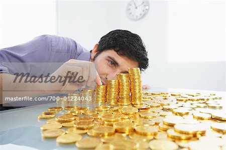 illustration of a businessman's hand saving gold coins in a piggy