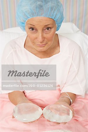 Portrait of Woman Holding Breast Implants