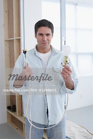 Man Holding Lightbulb and Cord