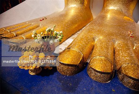 Flowers at Feet of Buddha Statue, Bangkok, Thailand