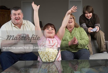 Family Playing Video Game with Popcorn