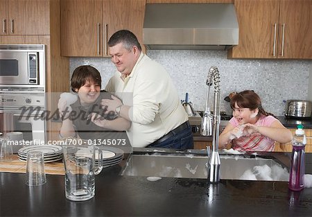 Father and Children Playing with Dishwater Suds