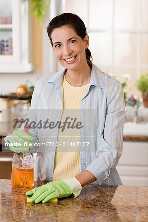 Woman Cleaning Kitchen Counter