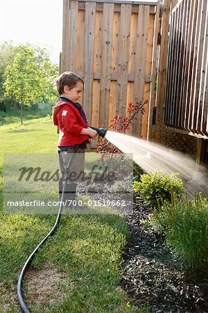 Boy Watering Garden