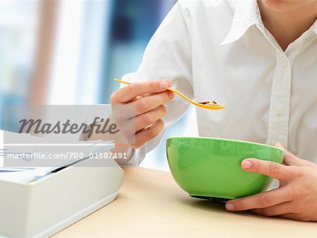 Businesswoman Eating Cereal