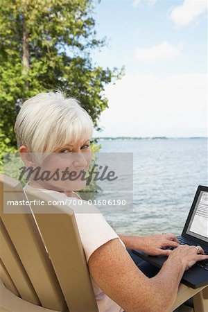 Woman with Laptop by Lake