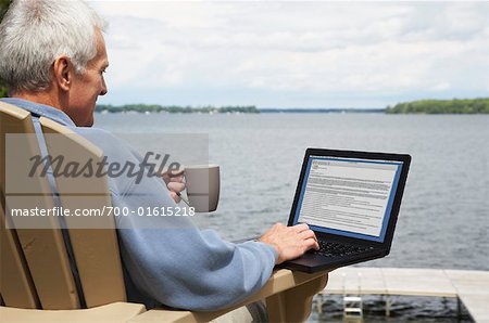 Man at the Cottage, Using Laptop Computer