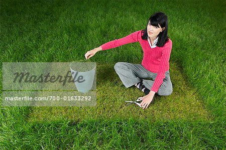 Woman Cutting Grass With Scissors