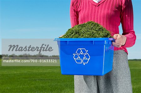 Woman Holding Recycling Box Full of Grass Clippings