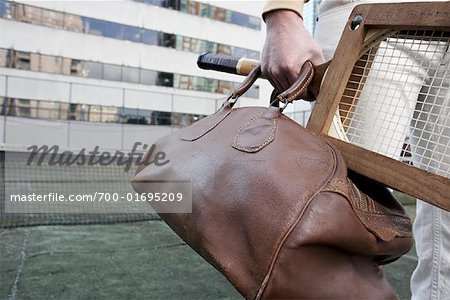 Close-up of Man holding Leather Gym Bag