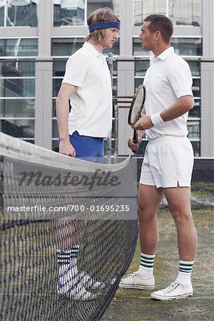 Tennis Rivals Standing at Net