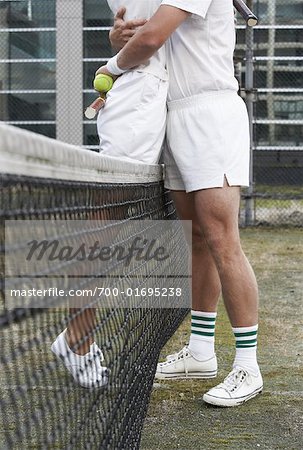 Tennis Players Embracing at Net