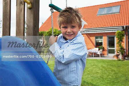 Boy Playing on Playground Equipment