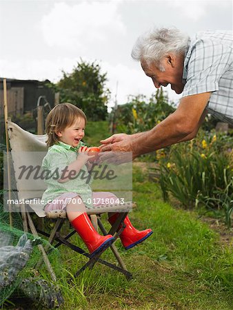 Man Giving Tomoto to Girl