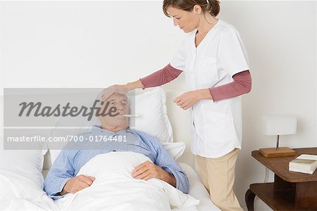 Nurse Taking Patient's Temperature