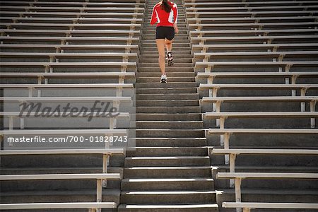 Woman Jogging up Bleacher Steps Stock Photo Masterfile