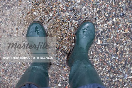 Person Wearing Boots in Water