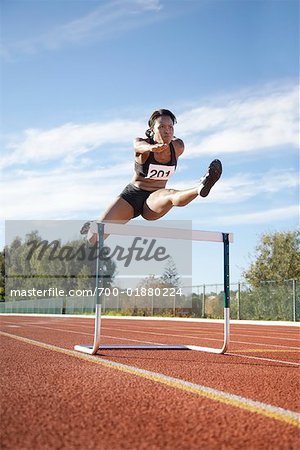 Woman Jumping Over Track Hurdle Stock Photo Masterfile Rights Managed Artist Blue Images Online Code 700