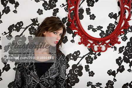 Woman Standing in Front of Black and White Wallpaper