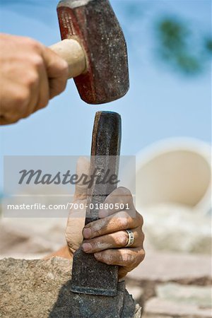 Man's Hand Chiselling Stone