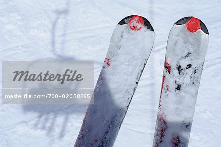 Skis and Shadow of Ski Lift on Snow