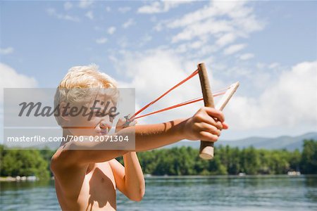 Boy Aiming with Slingshot