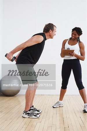 Man Exercising with Personal Trainer