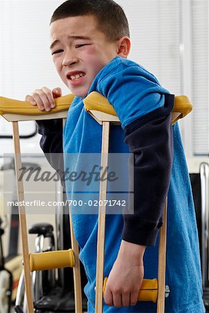 Portrait of Boy in Pain using Crutches