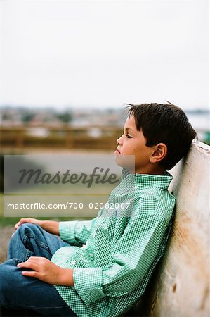 Portrait of Boy Sitting on Bench
