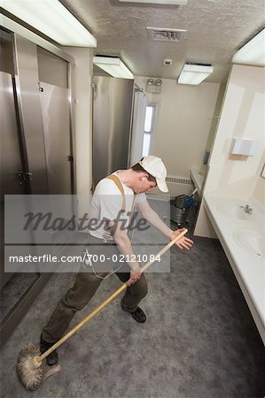 Janitor Listening to Music and Dancing With Mop