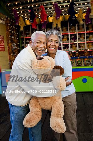 Couple Hugging and Holding Stuffed Toy, Santa Monica Pier Amusement Park, California, USA