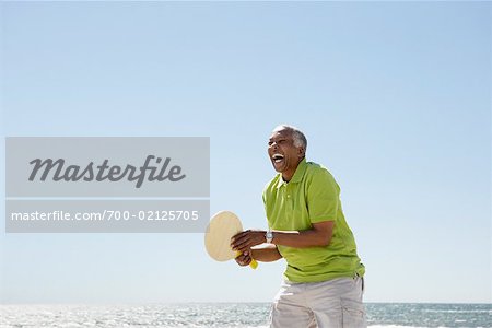 Man Playing Paddle Ball on Beach, Santa Monica Pier, Santa Monica, California, USA