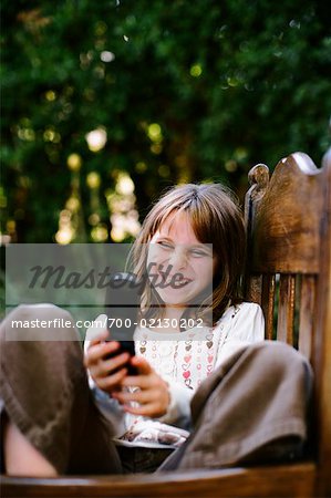 Girl in Chair with Cellular Phone