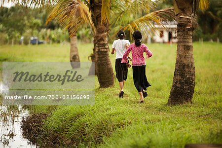 Women Running Along Riverbank, Bangalore, India