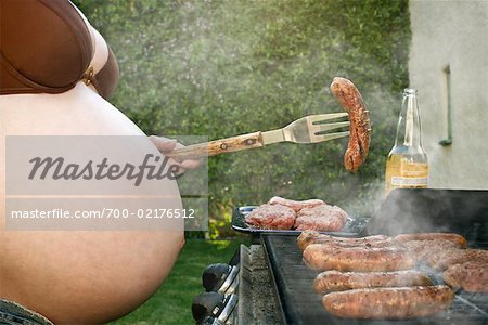 Pregnant Woman Cooking on Barbeque