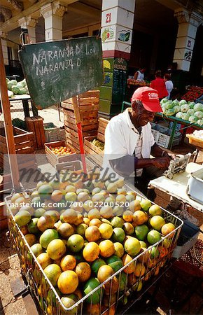 Man Peeling Oranges at Market, Havana, Cuba