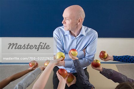 Students Handing Teacher Apples