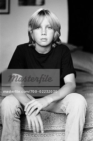 Boy Sitting on Bed