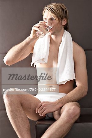 Man taking off underpants Stock Photos - Page 1 : Masterfile