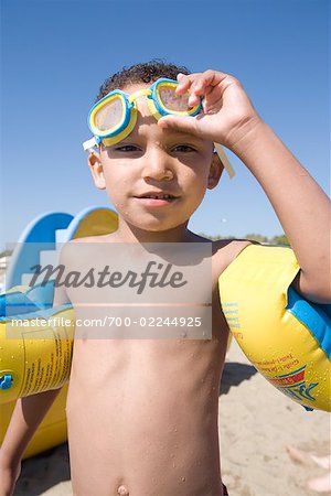 Boy on Beach with Water Wings and Eye Goggles