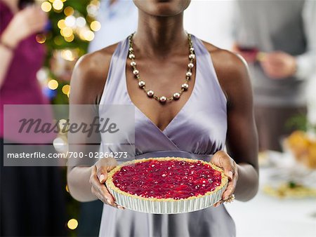Close-up of Woman Holding Pie at Christmas Party