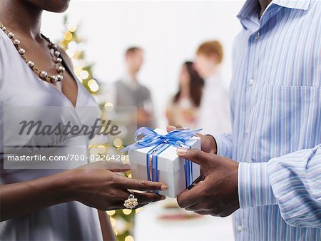 Man Giving Christmas Present to Woman